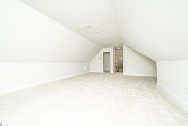 bonus room featuring light carpet and lofted ceiling