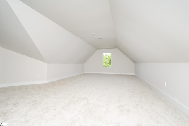 bonus room featuring light colored carpet and lofted ceiling