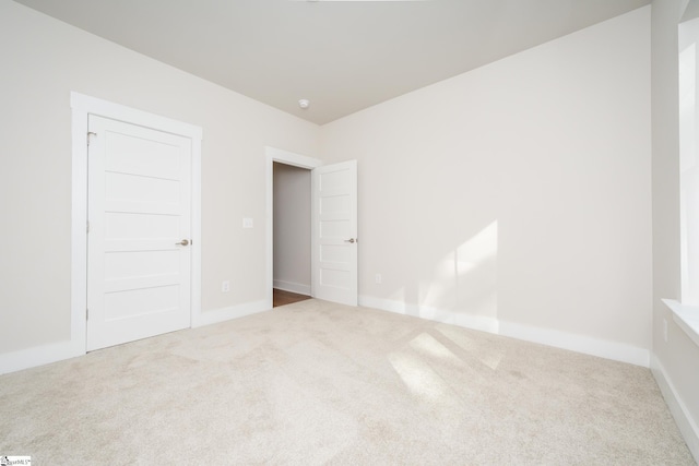 unfurnished bedroom featuring carpet flooring and a closet