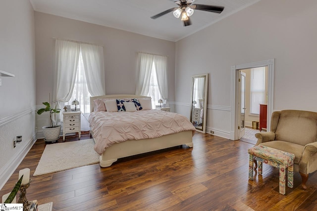 bedroom featuring ceiling fan, crown molding, and dark wood-type flooring