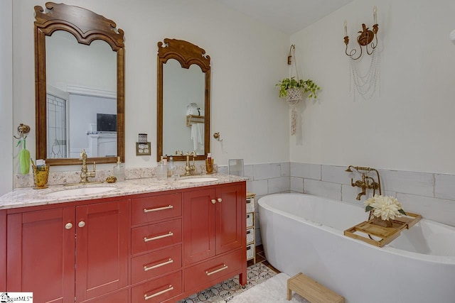 bathroom featuring vanity, tile patterned floors, and a bathing tub