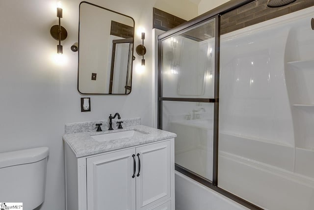 full bathroom featuring vanity, toilet, and enclosed tub / shower combo