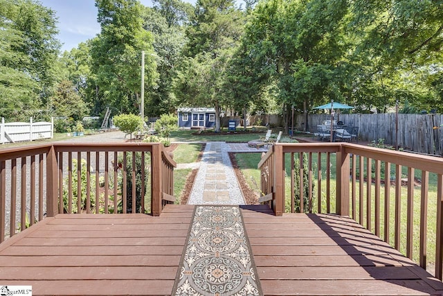 wooden terrace featuring an outbuilding