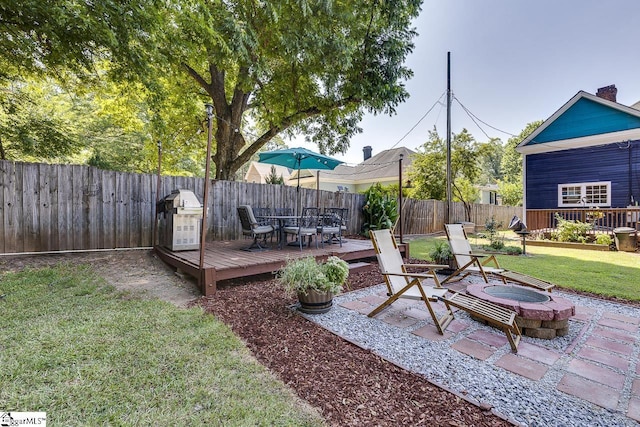 view of yard featuring a fire pit and a deck