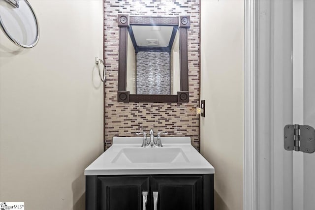 bathroom with decorative backsplash and vanity