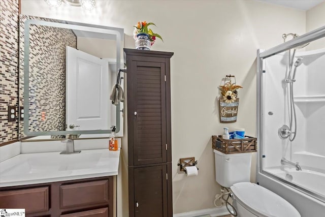 full bathroom featuring vanity, toilet, and bath / shower combo with glass door