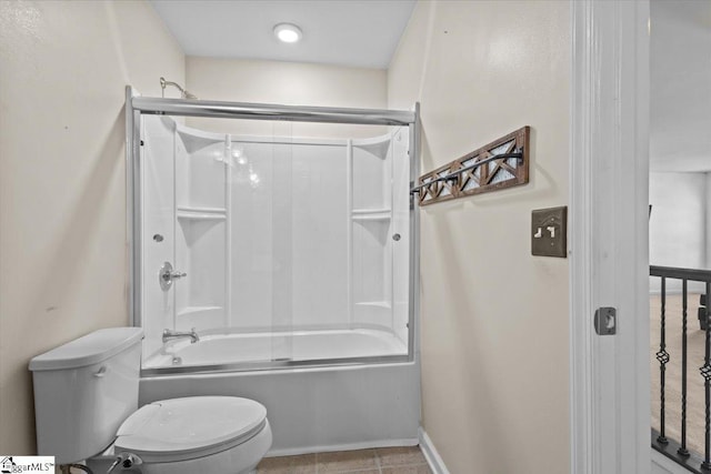 bathroom featuring tile patterned flooring, toilet, and shower / bath combination with glass door