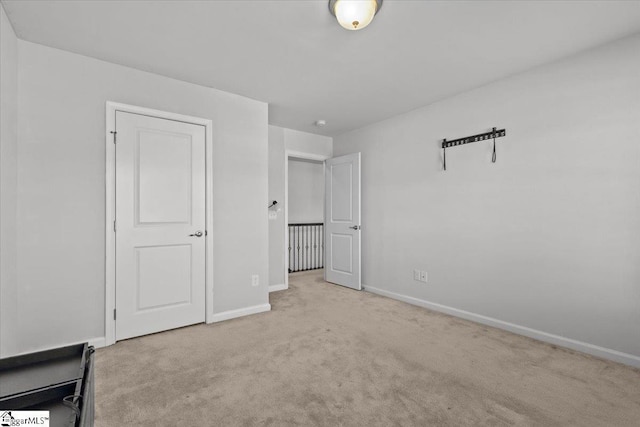 unfurnished bedroom with light colored carpet