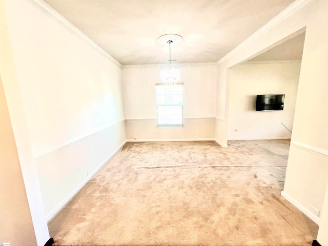 carpeted empty room with a notable chandelier and ornamental molding