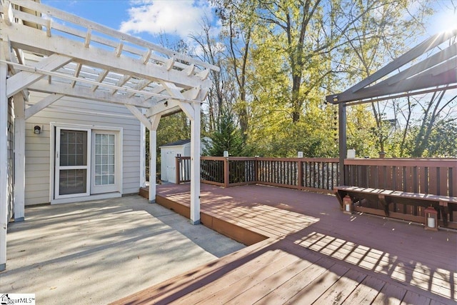 wooden terrace with a shed and a pergola