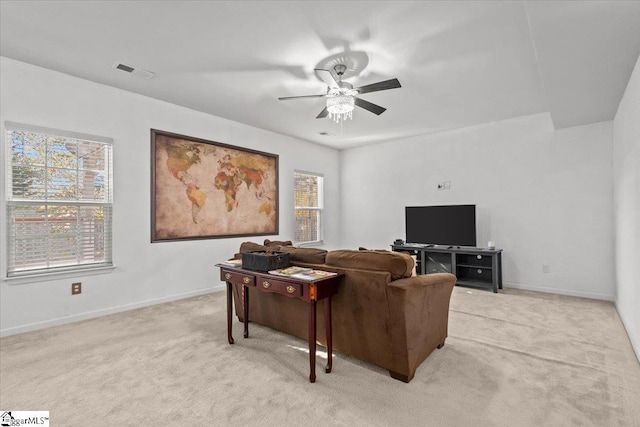 carpeted living room with ceiling fan