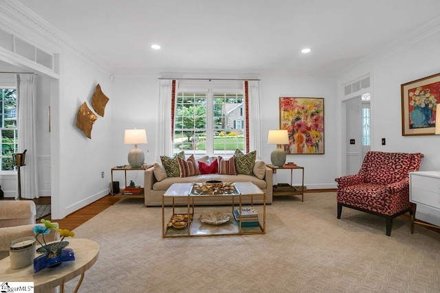 living room with ornamental molding and light hardwood / wood-style flooring