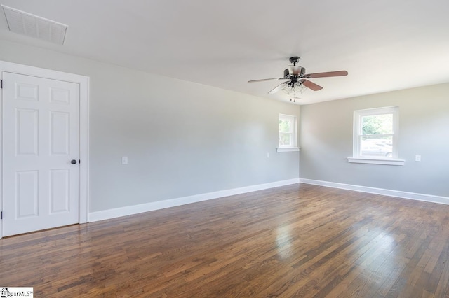 empty room with ceiling fan and dark wood-type flooring