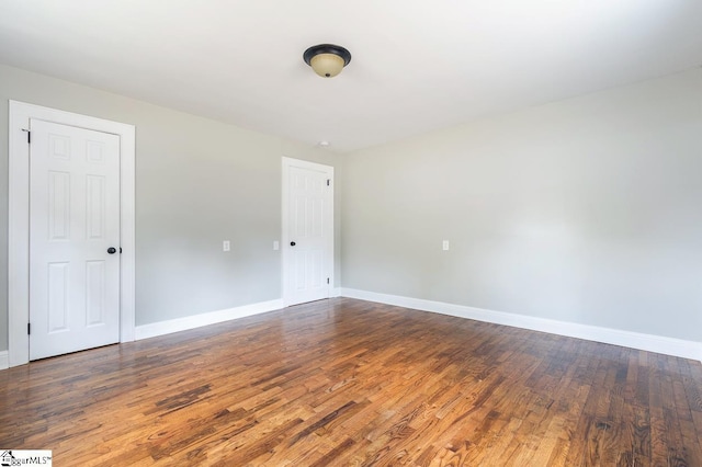 empty room featuring dark hardwood / wood-style flooring