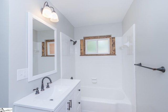 bathroom with vanity and tiled shower / bath combo