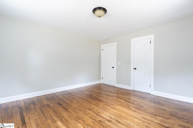 empty room with wood-type flooring