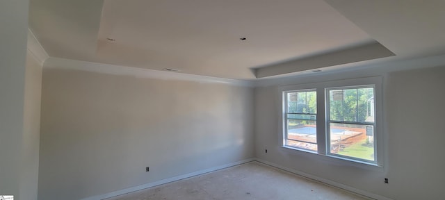 unfurnished room with a tray ceiling