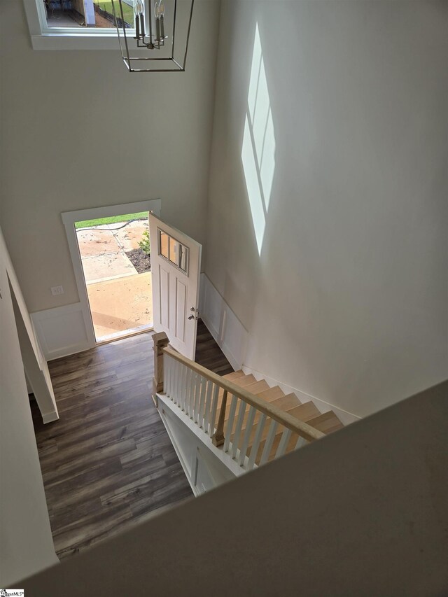 stairway with a chandelier