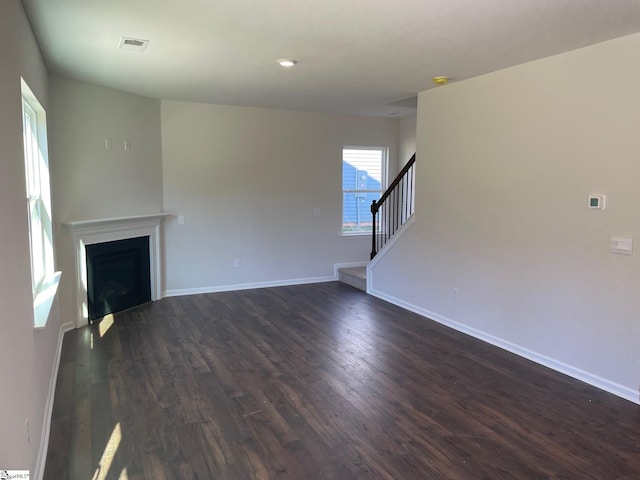 unfurnished living room with dark hardwood / wood-style flooring