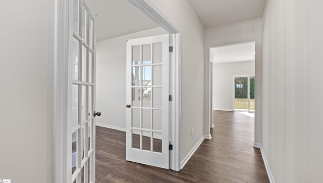 hallway with dark hardwood / wood-style flooring and french doors