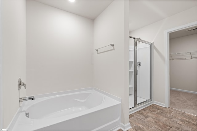 bathroom with separate shower and tub