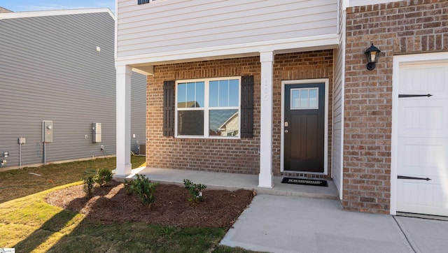 view of exterior entry featuring a porch