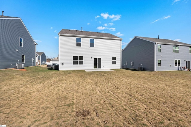 back of house with central AC unit, a yard, and a patio