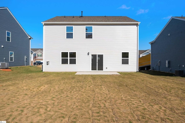 rear view of house featuring central air condition unit, a patio area, and a lawn