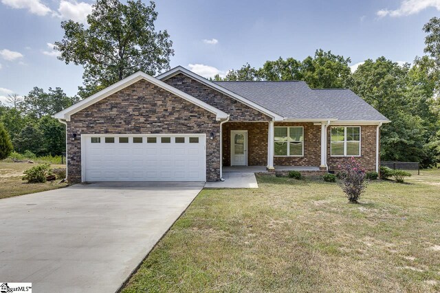 view of front of property featuring a garage and a front yard