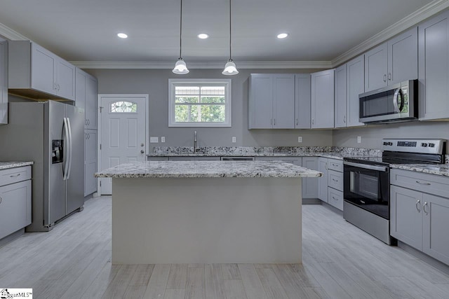 kitchen featuring gray cabinets, a center island, and appliances with stainless steel finishes