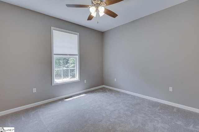 spare room featuring ceiling fan and carpet floors