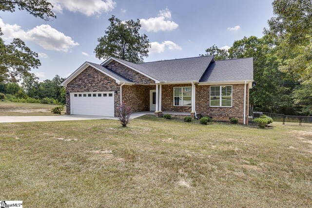 view of front of property with a garage and a front yard