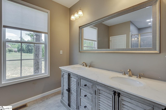 bathroom with vanity and a shower with shower door