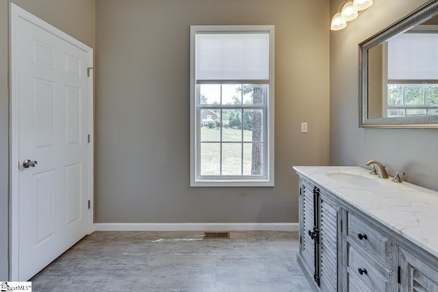 bathroom with vanity and hardwood / wood-style floors