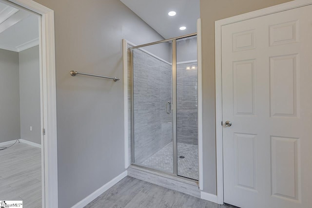 bathroom with an enclosed shower and wood-type flooring