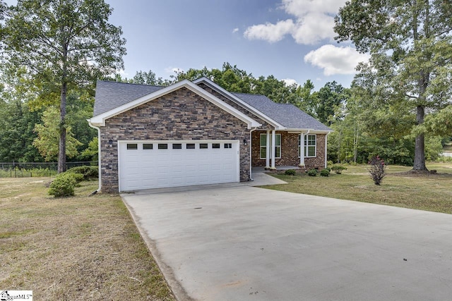 view of front of property with a garage and a front lawn