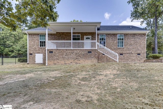 back of property featuring a lawn