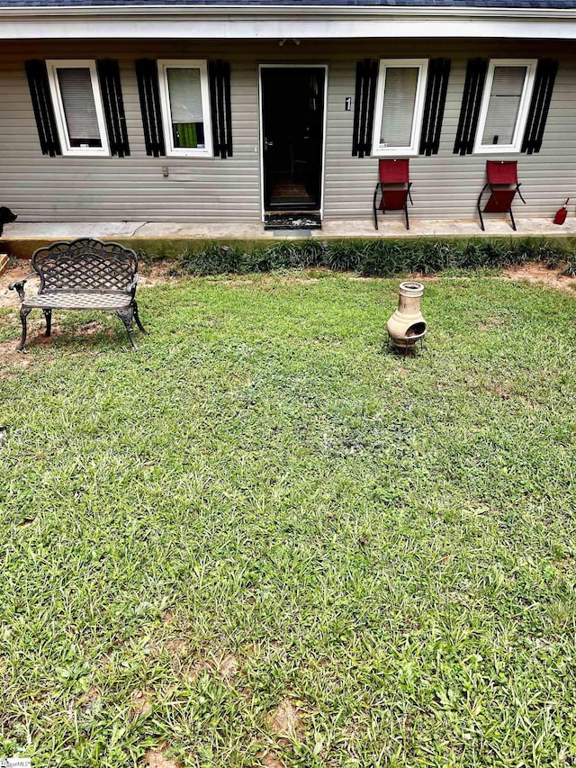 view of front facade with a patio and a front lawn