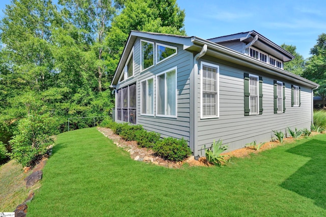 view of side of property with a lawn