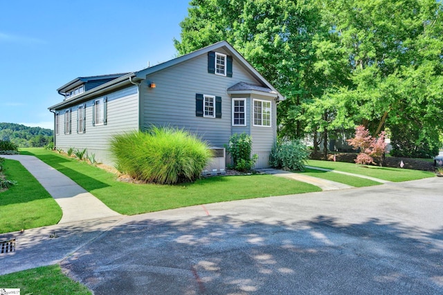 view of side of property featuring a yard