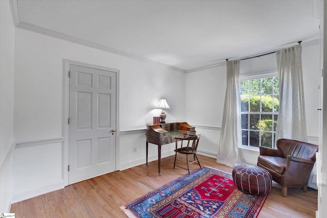 living area with wood-type flooring and crown molding