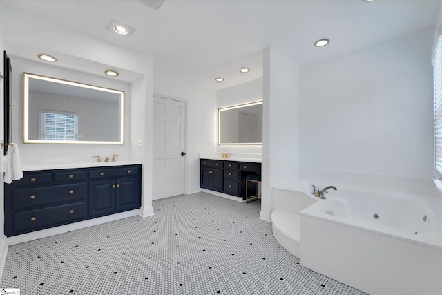 bathroom with a tub and vanity