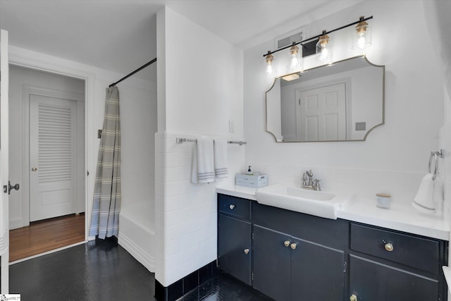 bathroom featuring wood-type flooring, vanity, and shower / tub combo with curtain