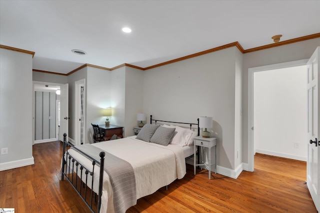 bedroom with wood-type flooring and crown molding