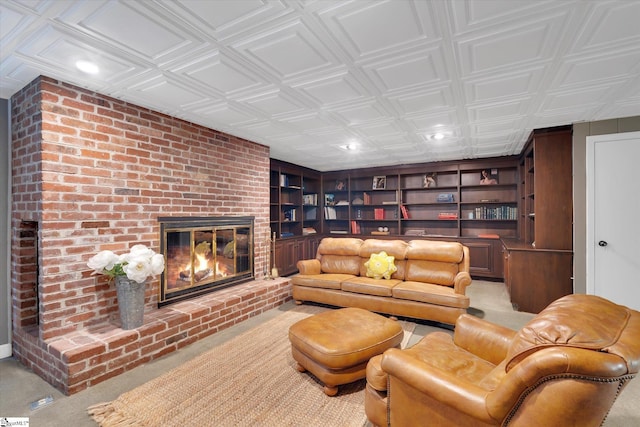 carpeted living room featuring built in shelves and a brick fireplace