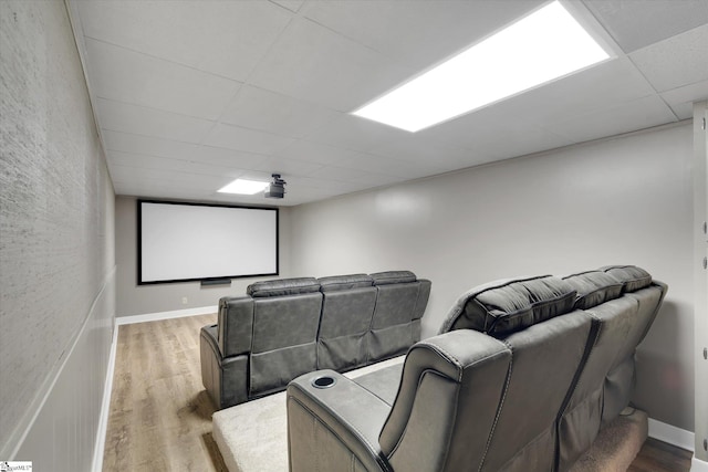 home theater with a drop ceiling and wood-type flooring