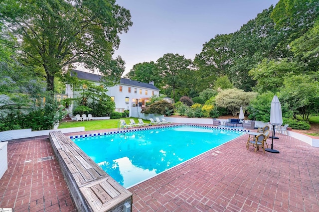 view of pool with a yard and a patio area