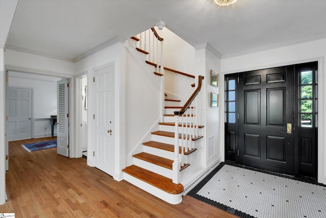 foyer featuring hardwood / wood-style floors and ornamental molding