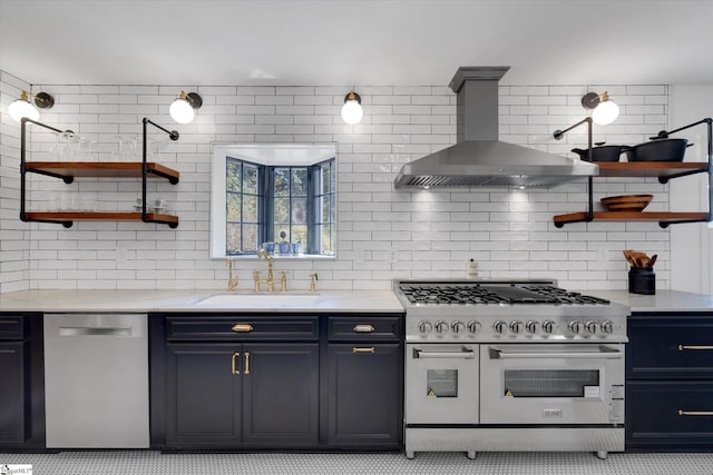 kitchen with sink, wall chimney exhaust hood, stainless steel appliances, light stone counters, and decorative backsplash