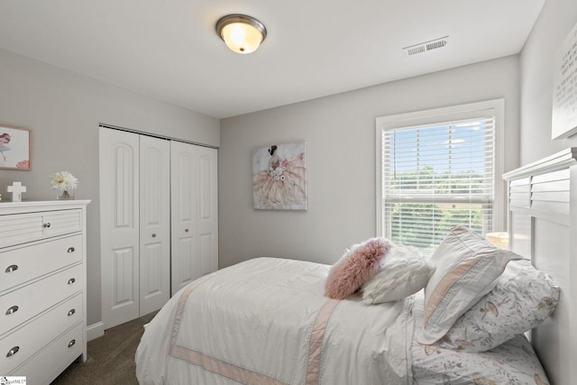 carpeted bedroom with a closet